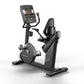 Matrix Performance Hybrid Cycle stationary recumbent exercise bike with digital console display, black frame and seat, on whi