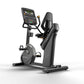 Matrix Performance Hybrid Cycle stationary exercise bike with digital console display, black seat, and pedals on white backgr