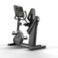 Matrix Performance Hybrid Cycle in black and gray with digital display console, seat, and foot pedals on white background