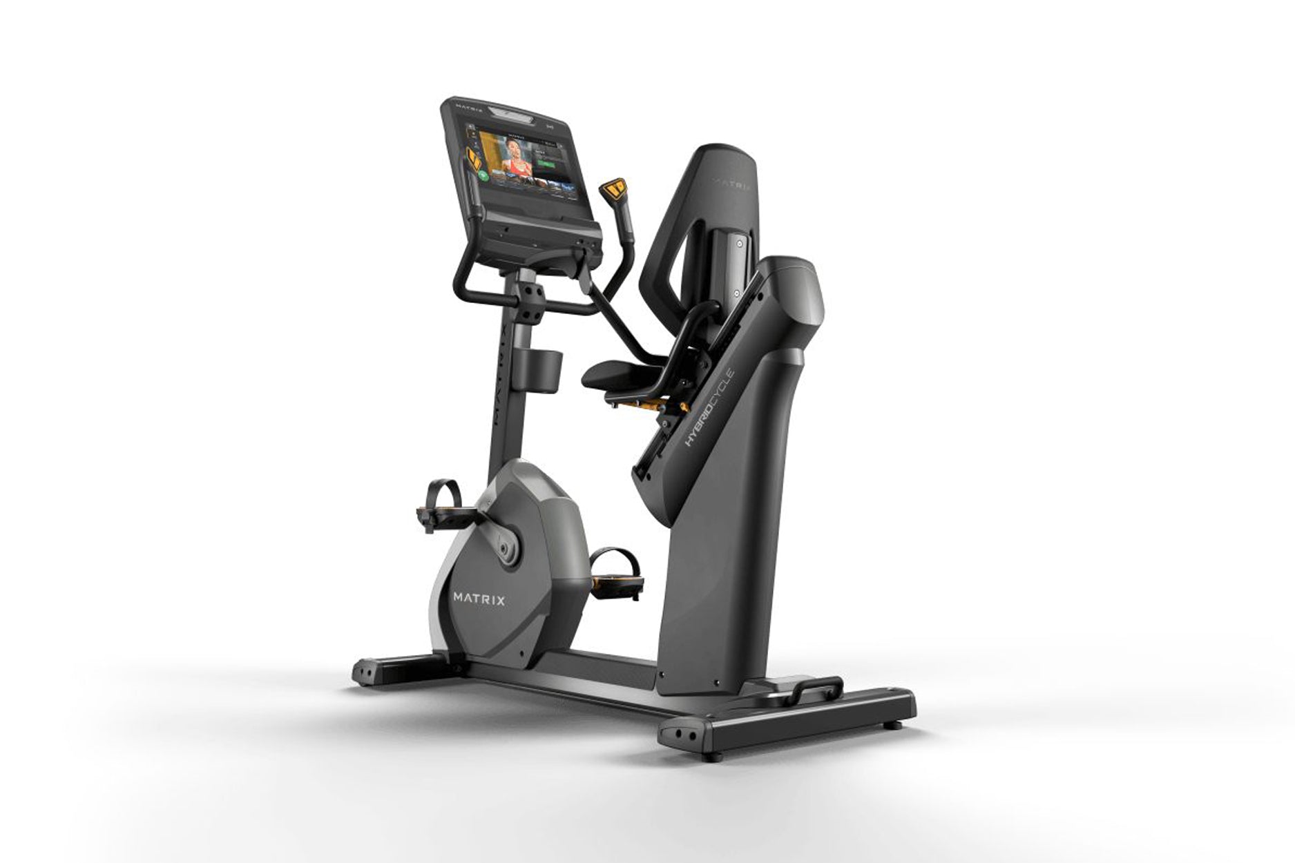 Matrix black stationary recumbent exercise bike with digital display screen and gold accents, on white background