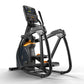 Black and orange elliptical trainer with digital display console, foot pedals, and dual handlebars on white background