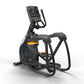 Black and gold elliptical machine with digital console displaying workout metrics on white background