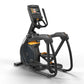 Black and orange elliptical trainer with digital display console, handlebar grips, and foot pedals on white background