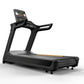 Black Matrix Performance Plus treadmill with digital display console, hand grips, and gray running deck on white background