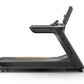 Black Matrix treadmill with digital console, adjustable incline, and yellow accent stripe on running belt against white backg