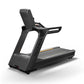 Matrix Performance Plus treadmill with black frame, gray running deck, digital display console, and handrails on white backgr