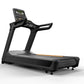Black motorized treadmill with digital display console, dual handles, gray running deck with orange accent stripe, and wheels