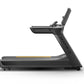 Black Matrix performance treadmill with gray accents, digital console, and yellow stripe on running deck, shown from the side
