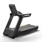 Black Matrix Performance Plus treadmill with padded backrest, handrails, and textured running belt on white background