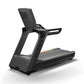 Matrix Performance Plus treadmill with black frame, gray running deck with orange accent stripe, and cushioned backrest on wh