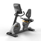 Matrix performance recumbent exercise bike with black seat, gray base, digital display console, and yellow accent details on 