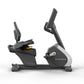 Matrix Performance recumbent exercise bike with black and gray frame, dual upright handles, and seat, shown on white backgrou