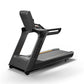 Matrix Performance Treadmill with black frame, gray running deck with gold accents, digital console, and handrails on white b