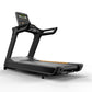 Black commercial treadmill with digital display showing time, gray running deck, orange accent stripe, and dual handlebars on