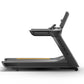 Matrix Performance Treadmill in black with digital console, yellow accent stripe, and adjustable incline, side view on white 