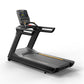 Black motorized treadmill with digital display console, yellow and red accent details, and extended handrails on white backgr