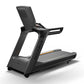 Matrix Performance Treadmill with black frame, gray running deck with orange accent stripe, and padded backrest on white back