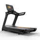 Black Matrix treadmill with digital touchscreen display, gray running deck, and orange accent stripe on white background