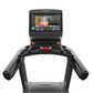 Matrix Performance Treadmill with black frame, dual handles, and console displaying fitness video on white background