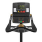 Matrix Performance Upright Exercise Bike with black frame, digital display showing time and metrics, gold accent buttons, and
