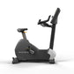 Matrix upright stationary exercise bike with black frame, gray seat, and adjustable handlebar on white background
