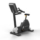 Matrix Performance Upright Cycle with black and white frame, digital console, black seat, and pedals on white background