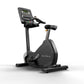 Matrix Performance Upright Cycle with digital console display, black frame, padded seat, and handlebars on white background