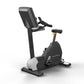 Matrix black and white upright exercise bike with digital display, pedals, and adjustable seat on white background