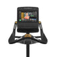 Matrix Performance Upright Cycle with black frame, gold accents, digital display screen showing workout content, and dual han