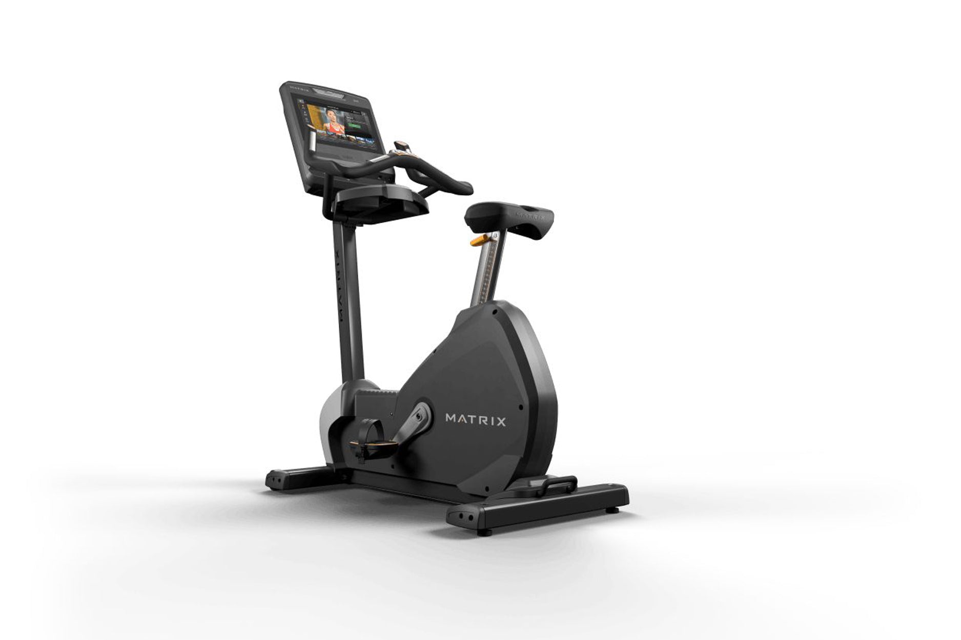 Black Matrix upright stationary bike with digital touchscreen display and gold accents, on white background