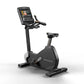 Matrix black upright exercise bike with digital touchscreen console, adjustable handlebars and seat, on white background