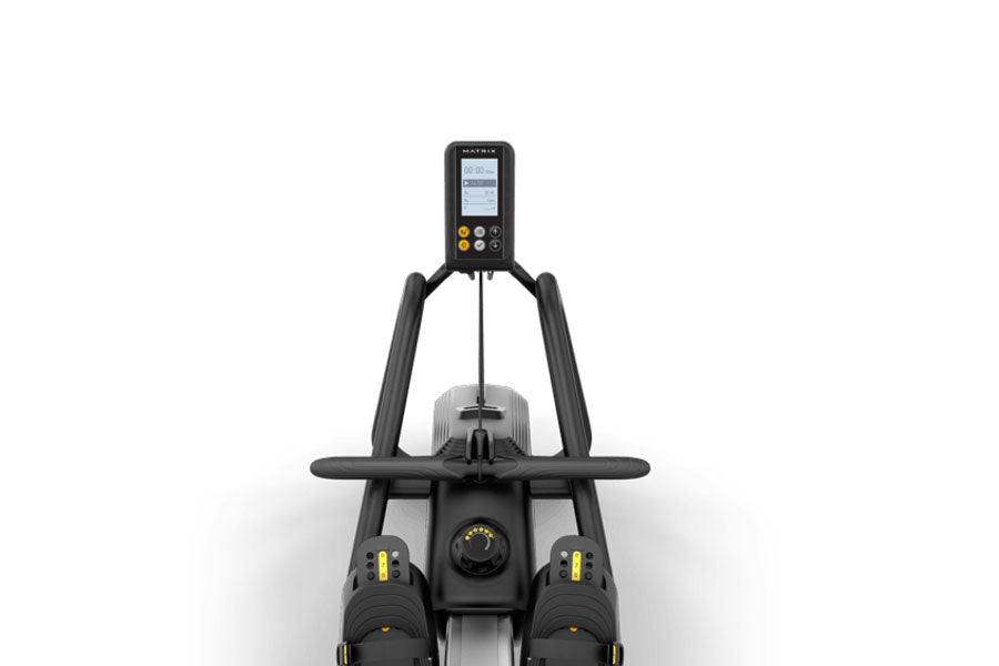 Black Matrix rowing machine with digital console, dual foot platforms, and ergonomic handles on white background