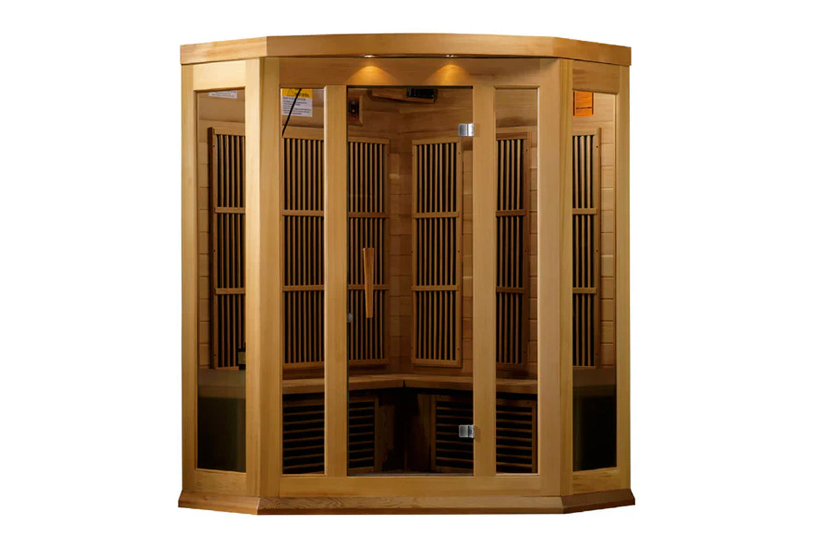 Natural wood corner infrared sauna with glass doors, vertical slat vents, interior bench seating, and overhead lighting on wh