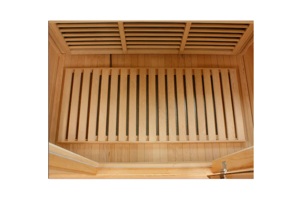Interior view of wooden sauna showing cedar bench seating and slatted ceiling ventilation