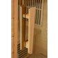 Natural wood door handle on cedar sauna door, showing cylindrical pull handles with metal hardware detail