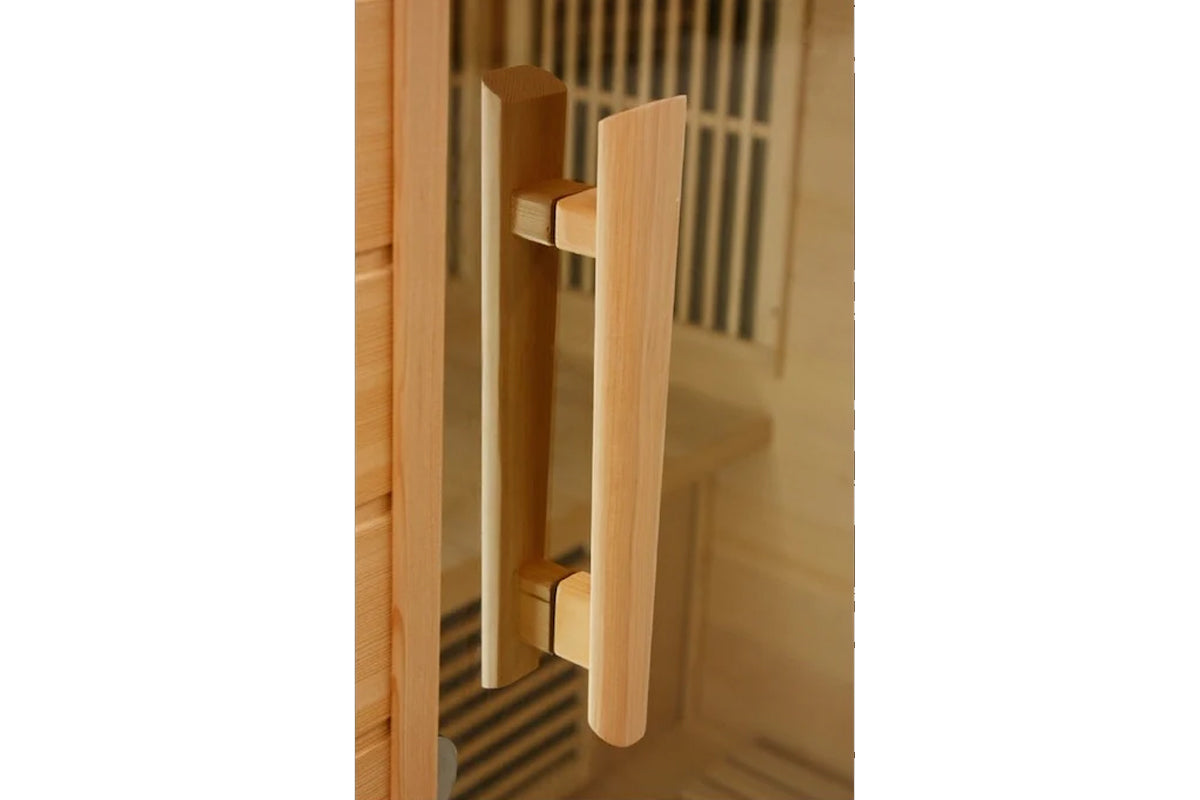 Natural wood door handle on cedar sauna door, showing cylindrical pull handles with metal hardware detail