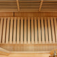 Interior view of wooden sauna cabin showing cedar slat benches and ventilation grates on ceiling