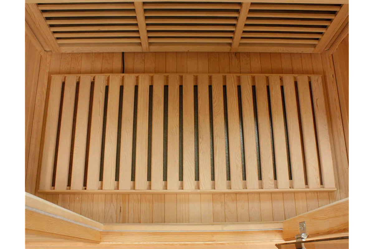 Interior view of wooden sauna cabin showing cedar slat benches and ventilation grates on ceiling
