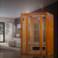 Golden cedar 2-person infrared sauna with glass door and vertical vent panels, shown in modern living room setting