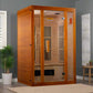 Orange wood two-person infrared sauna with glass doors and wooden bench interior, displayed in home setting