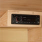 Black digital car stereo with red knob and FM/AM display mounted in light wood panel, showing CD player and audio controls