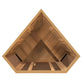 Interior view of triangular wooden sauna with cedar construction, bench seating, ventilation panels, and heating elements vis