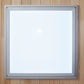 Gray aluminum framed mirror with white glass surface mounted on wooden wall background