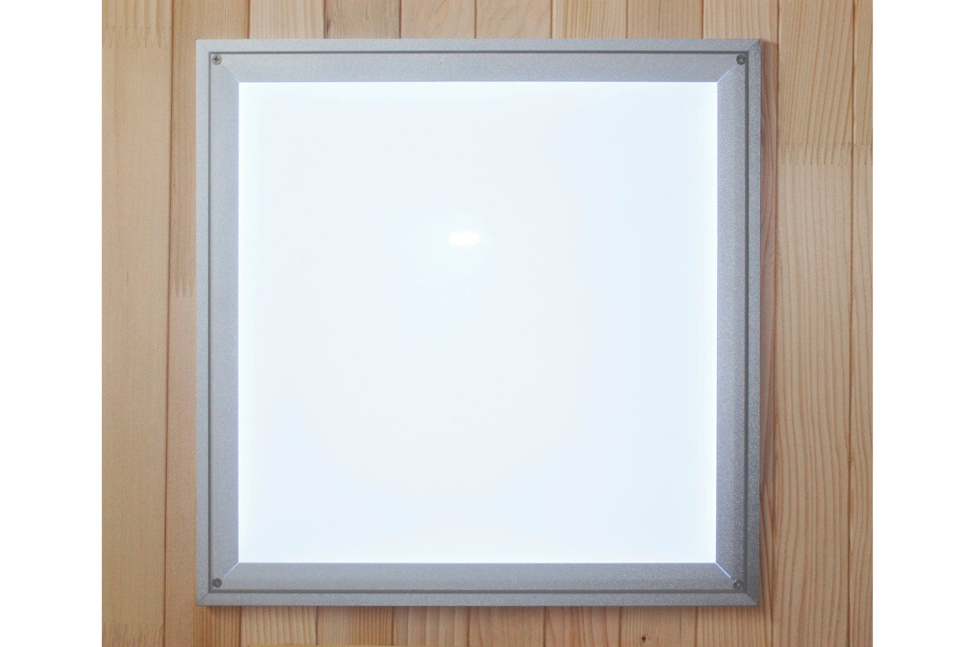 Gray aluminum framed mirror with white glass surface mounted on wooden wall background