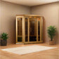 Light wood infrared sauna with glass doors and wooden bench interior, displayed in room with potted plants and cream mat on w