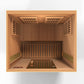 Overhead view of wooden infrared sauna interior with two bench seats, heating panels on walls and ceiling, overhead vents, an