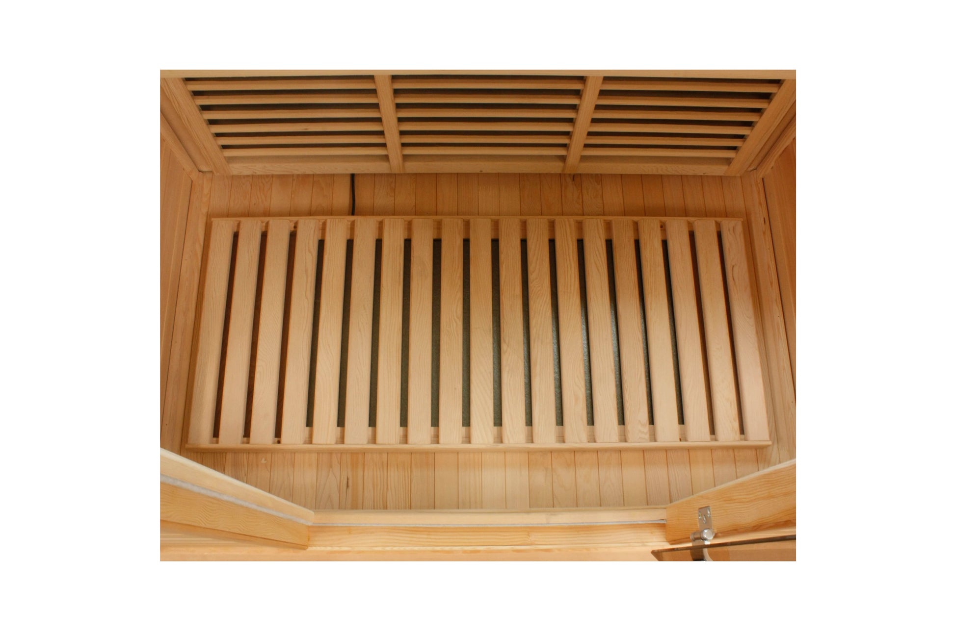 Overhead view of wooden sauna interior with slatted bench seating and ventilation louvers on cedar walls