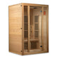 Natural wood far-infrared sauna cabin with glass front door, wooden benches, and vertical heater panels inside on white backg