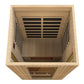 Light wood infrared sauna with two black heating panels on ceiling, viewed from above showing wooden bench interior and contr