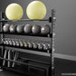 Black metal storage rack with five shelves holding two yellow exercise balls, six gray medicine balls, numbered dumbbells, an